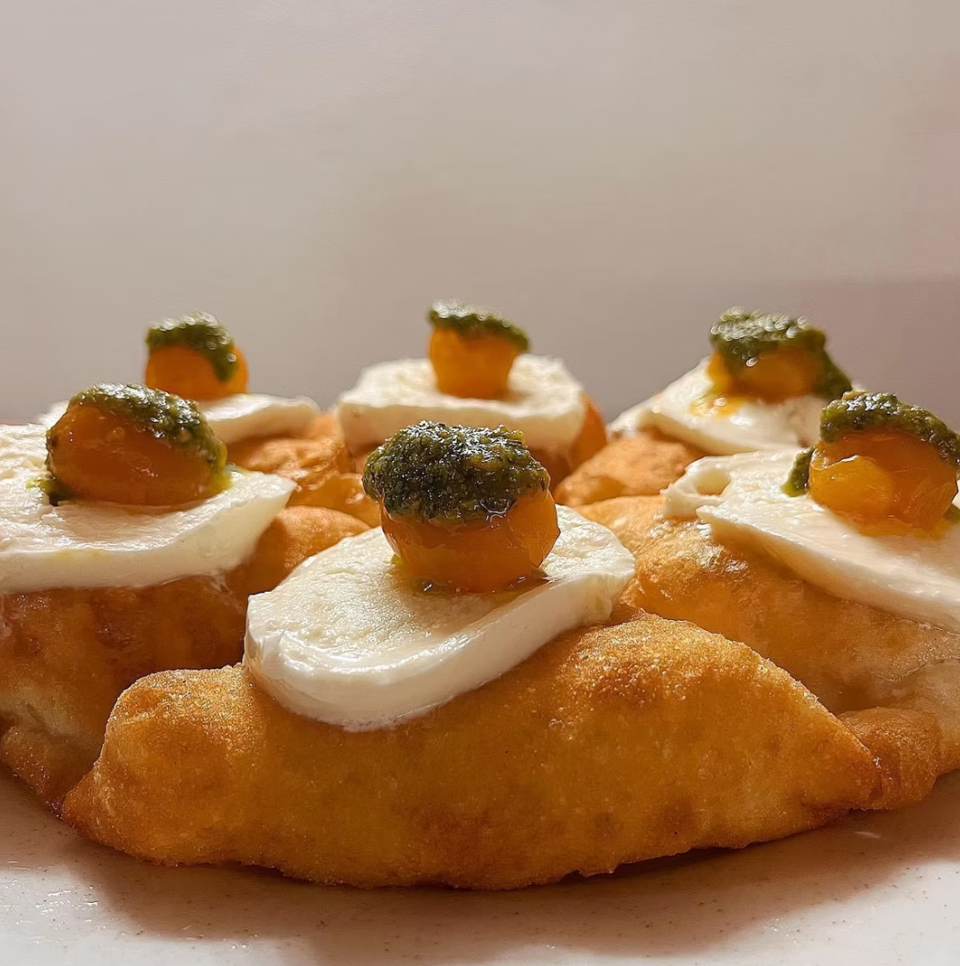 Montanare with fresh buffalo mozzarella, pesto, and roasted yellow tomato