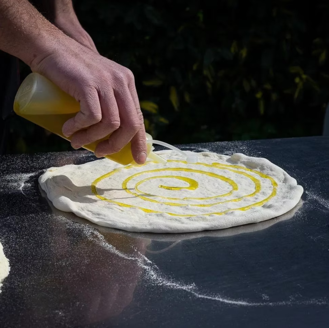 Hands-on Mediterranean cooking — olive oil spiral on fresh dough